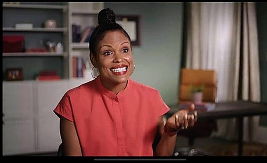 Woman smiling during an on-camera interview