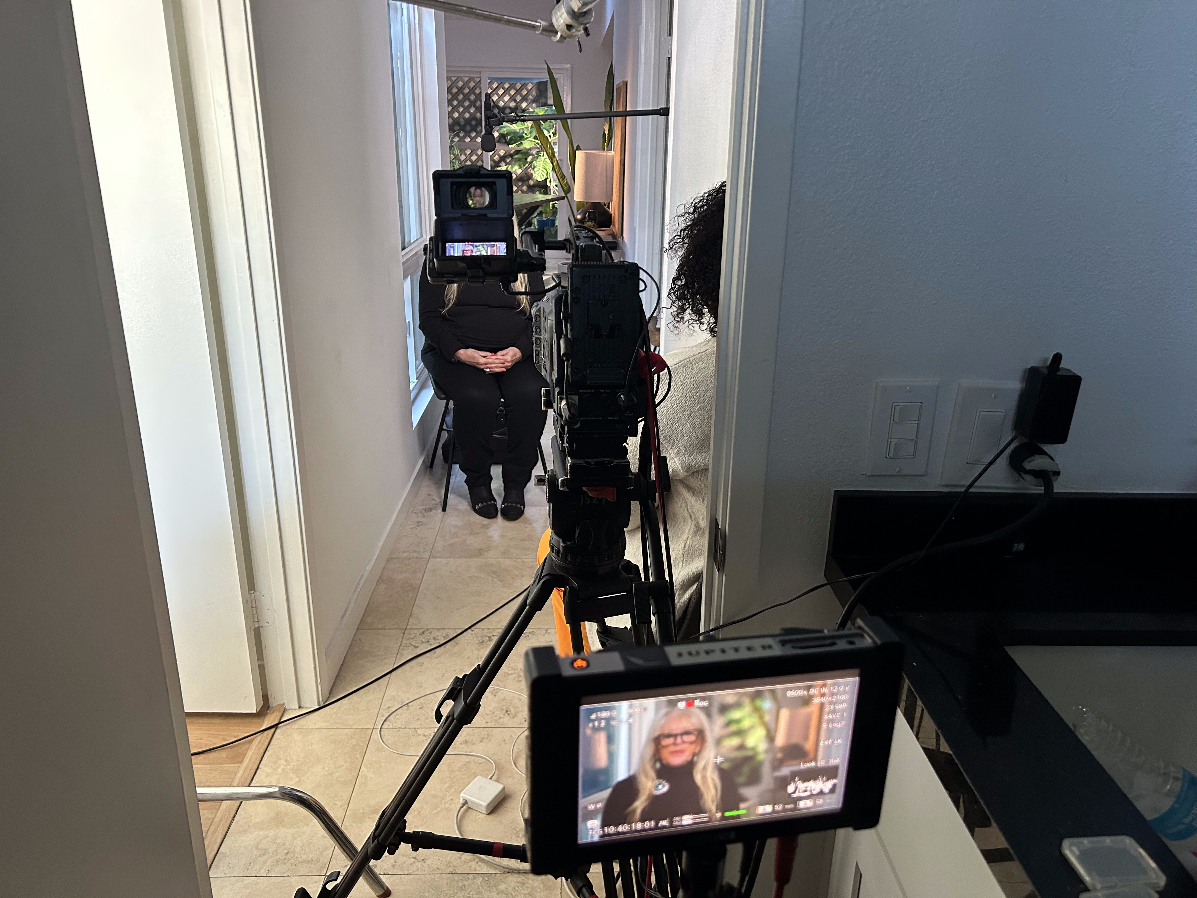 Camera framed through a hallway for a candid interview shot