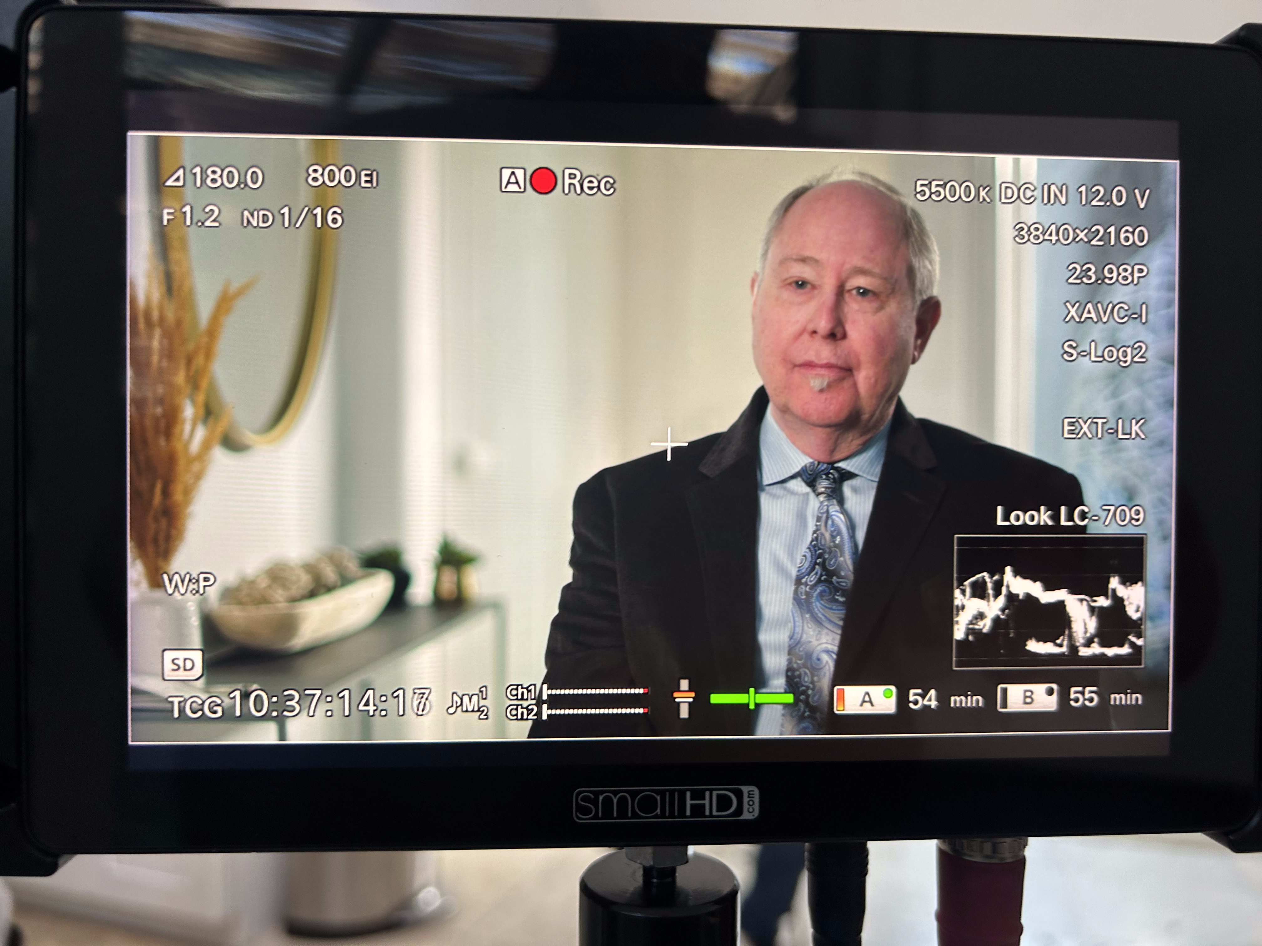 Monitor playback with technical camera readout of an interview subject in a suit