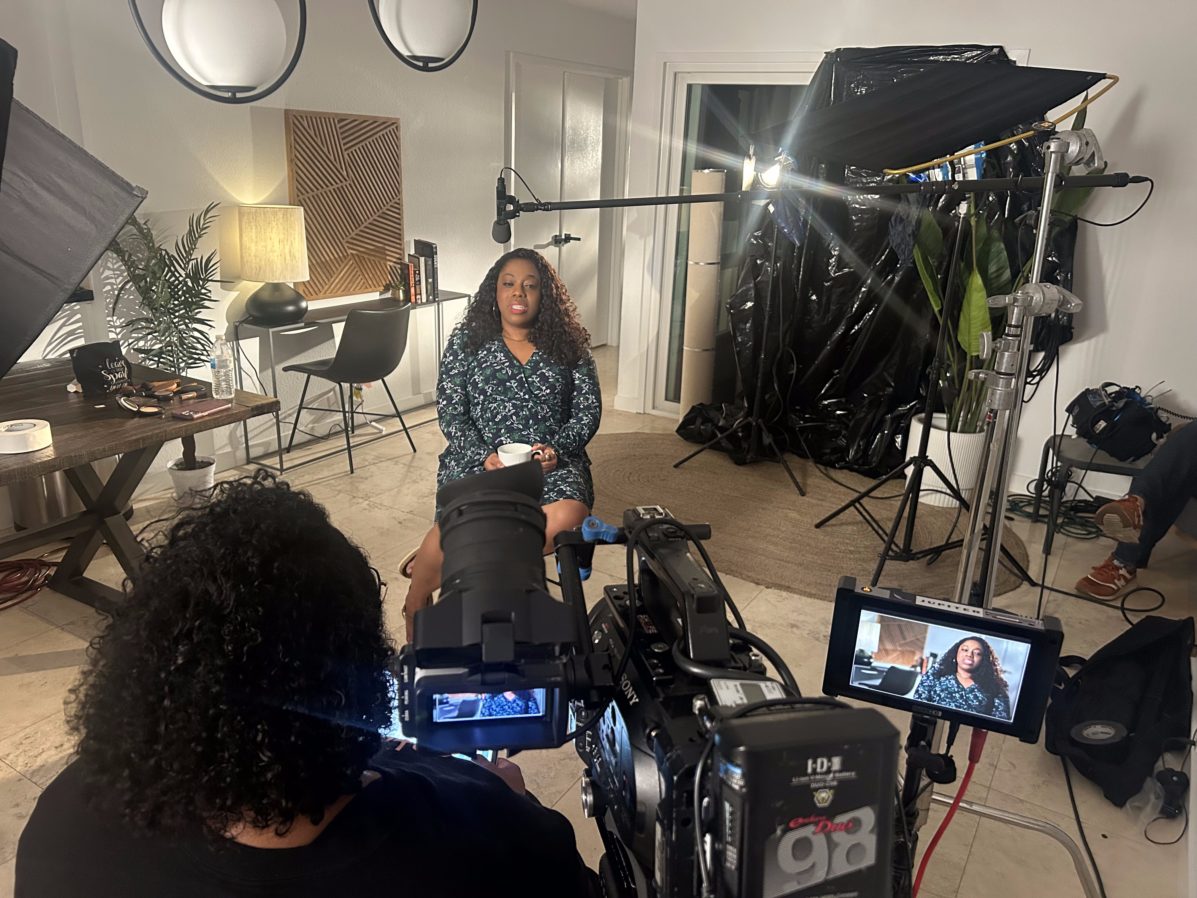 Camera operator and crew filming an interview subject
