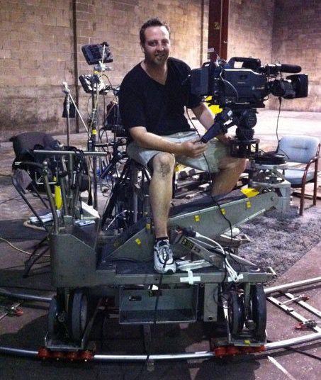 Camera operator on a Fisher 11 dolly rig for a corporate shoot