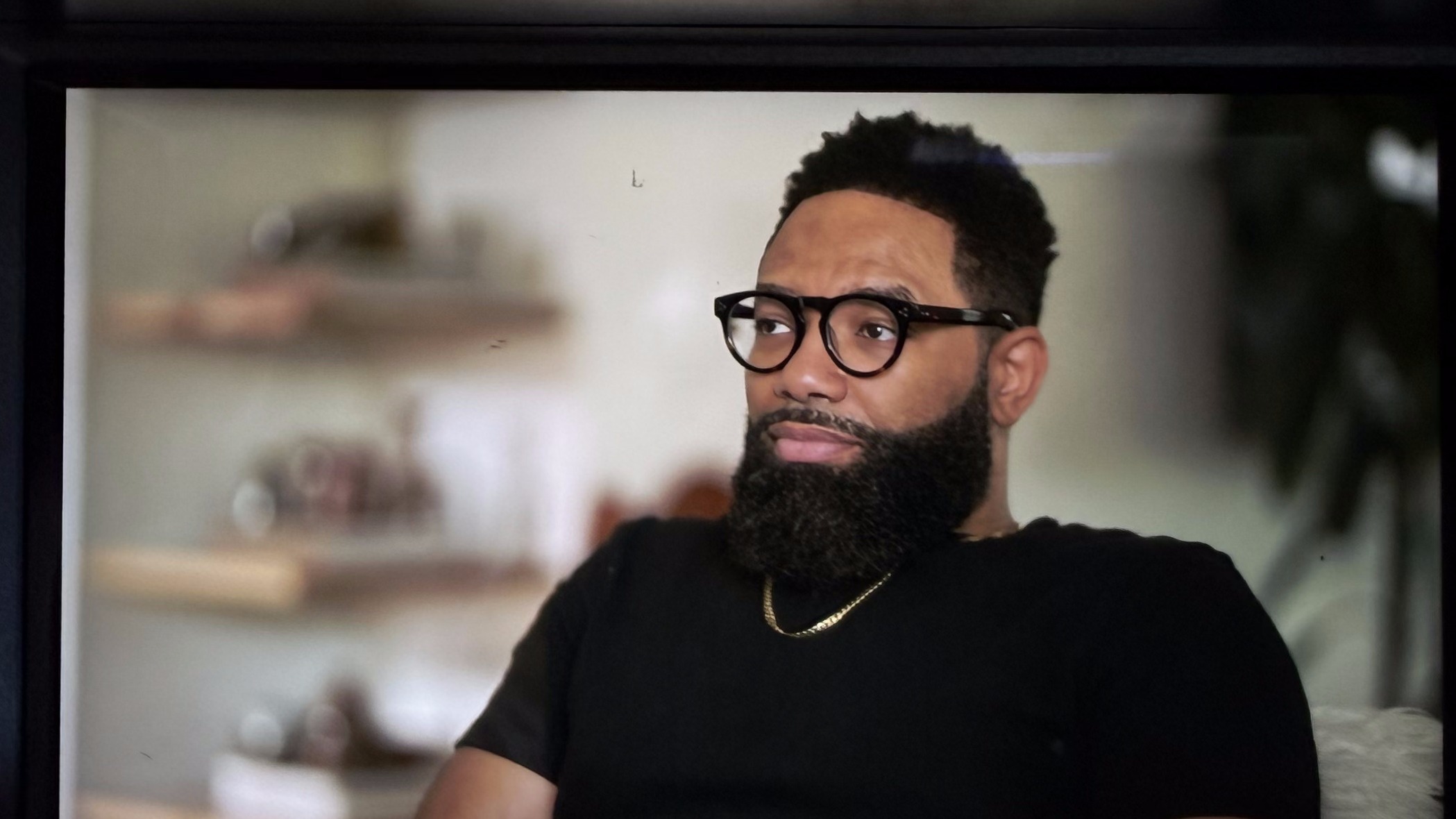 Monitor playback of an on-camera interview subject with glasses and beard
