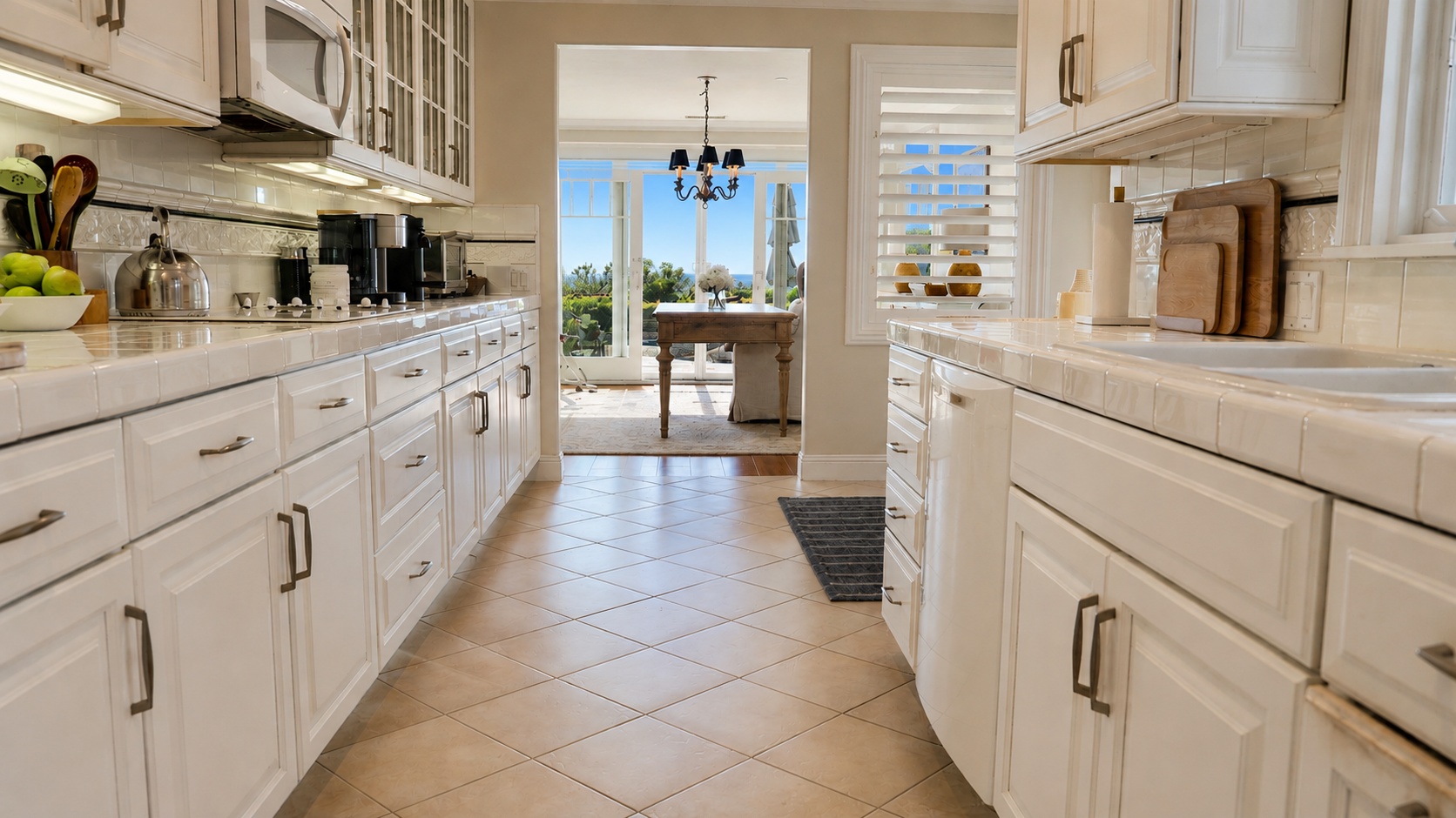 Kitchen with tile floors and view to dining area