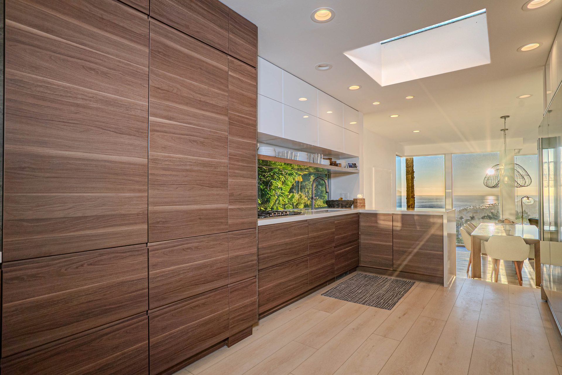 Walnut kitchen with island seating and ocean view window