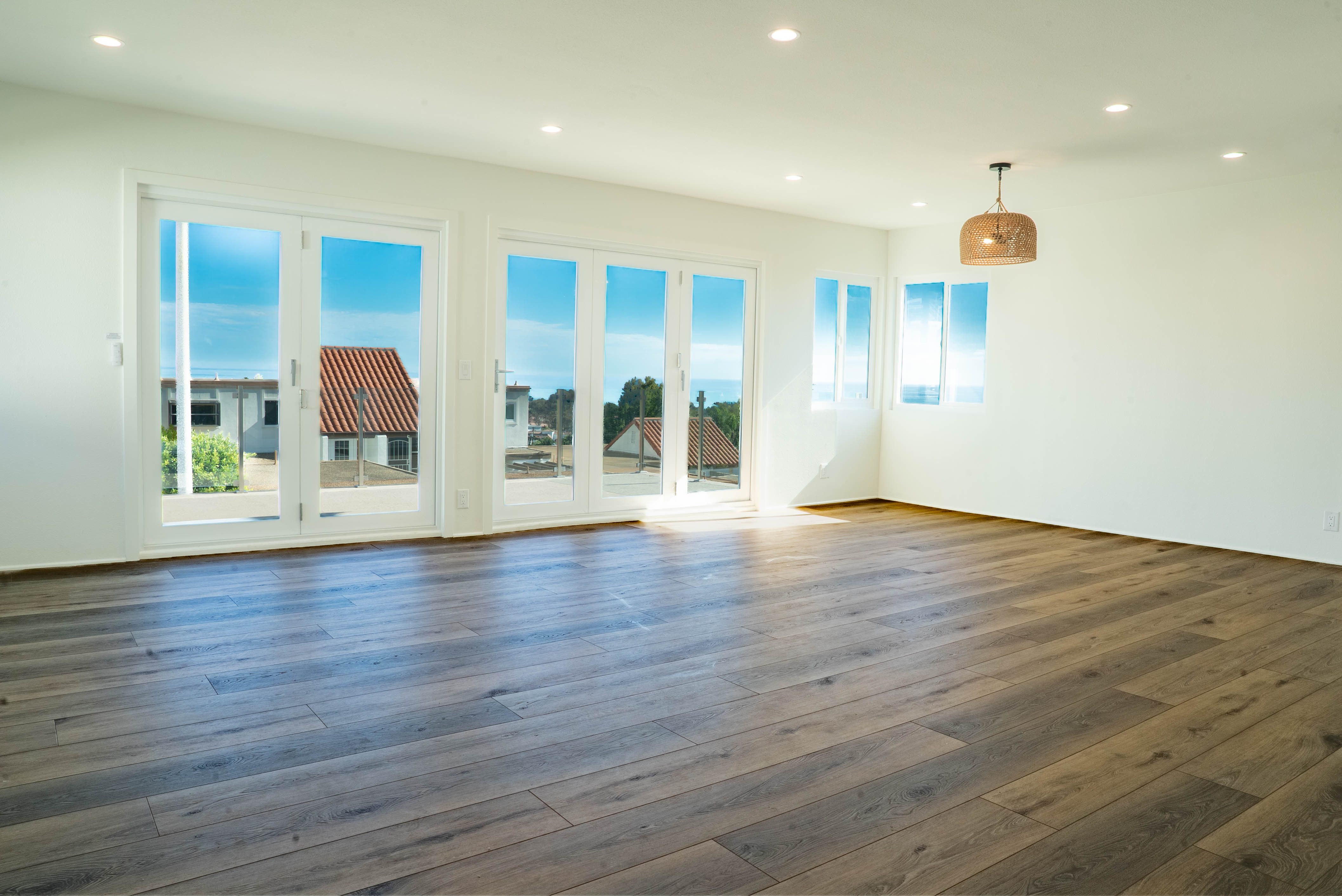 Living room with sliding glass doors and pendant light fixture