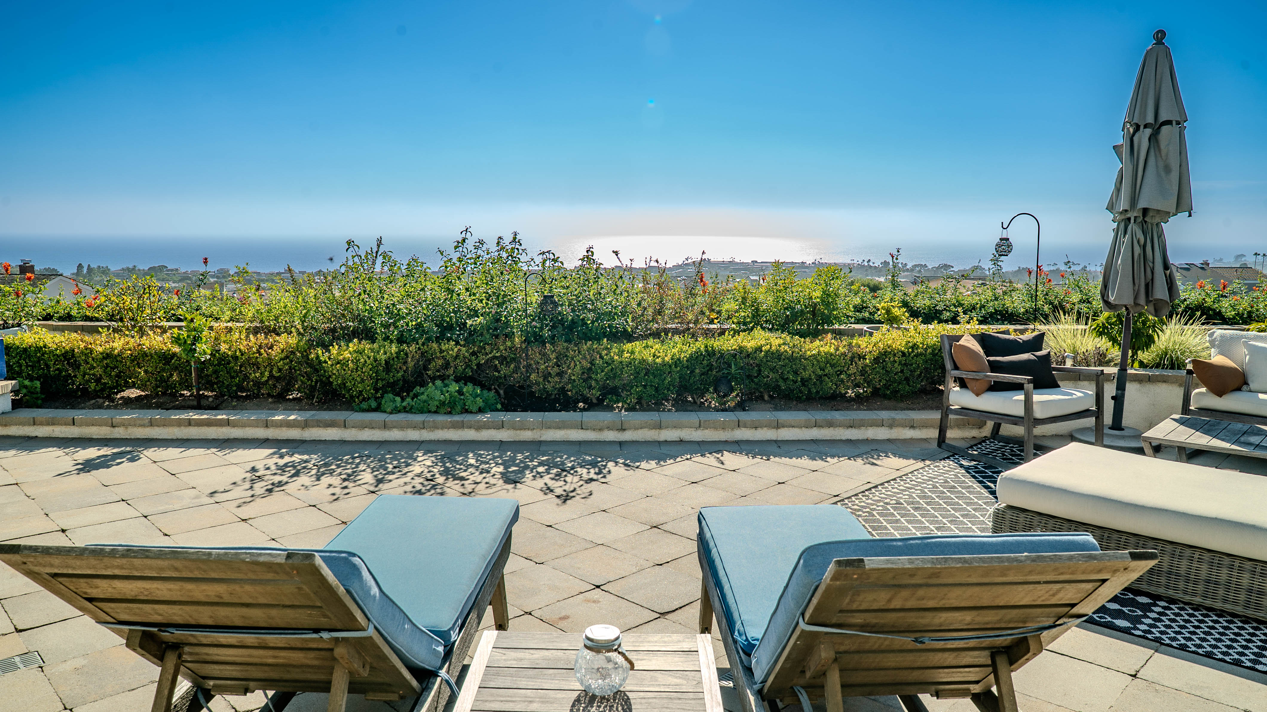 Rooftop lounge chairs with ocean sunset view